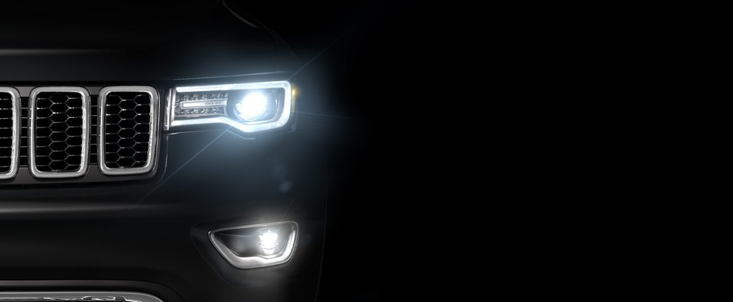 Close-up of the headlamps and Daytime Running Lamps illuminated on the 2020 Jeep Grand Cherokee.