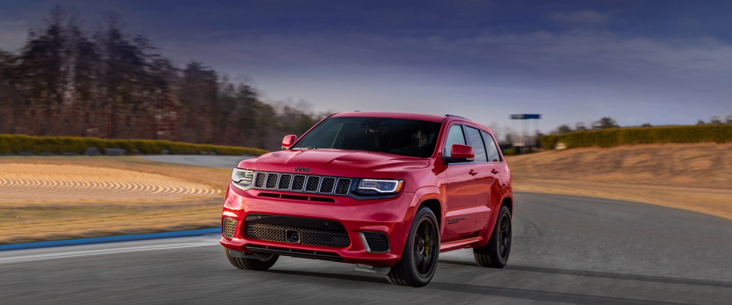 A 2020 Jeep Grand Cherokee Trackhawk rounding a curve on a racetrack.