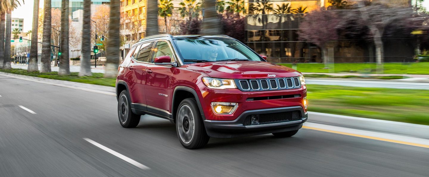 The 2021 Jeep Compass being driven on a city street.