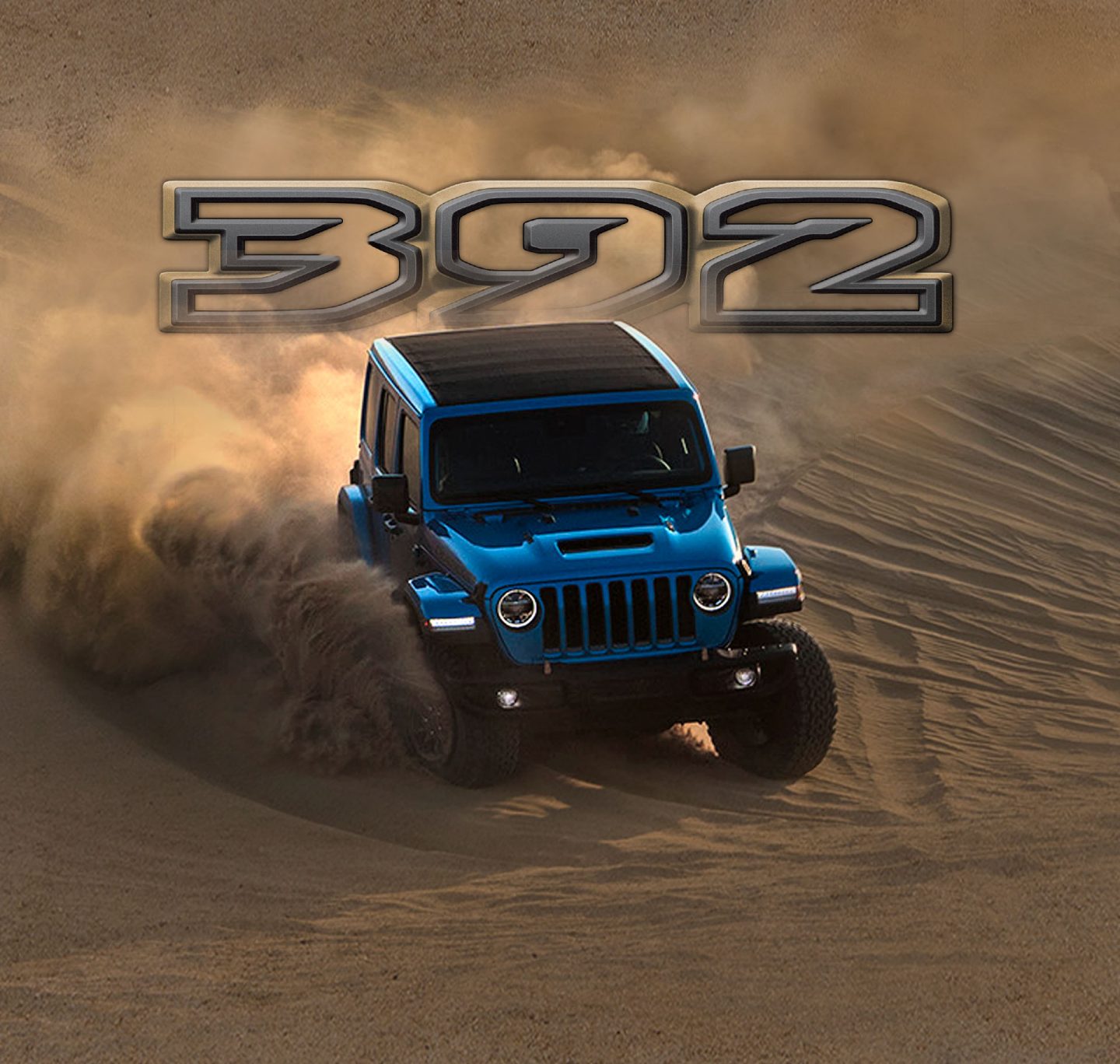 The 392 logo positioned above the 2022 Jeep Wrangler 392 decending a sandy hill as it kicks up dust.